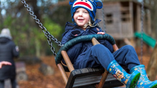 Young boy on a swing at Strawberry Castle